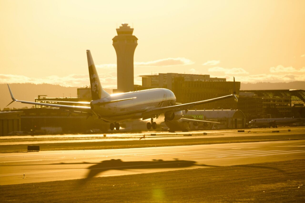 Picture of a plane landing in the sunset