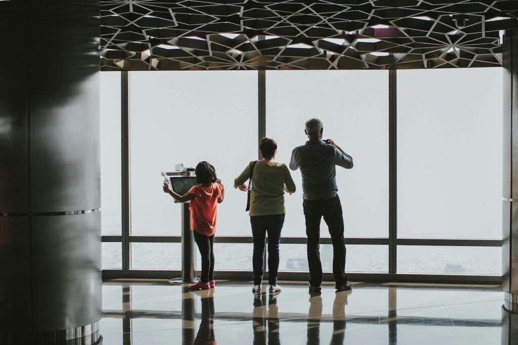Picture of a family looking out of a window at an airport