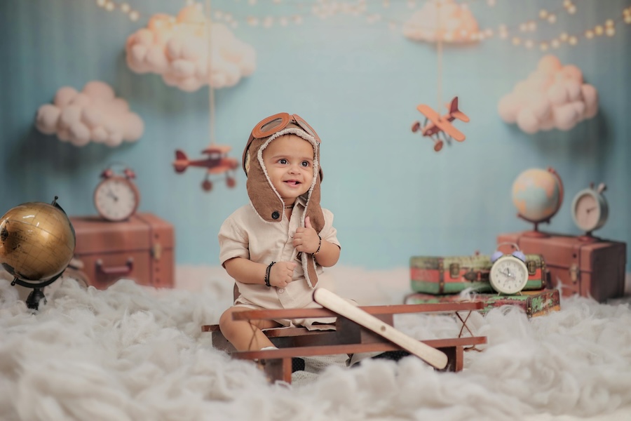 Child in a flying cap sat in his bedroom