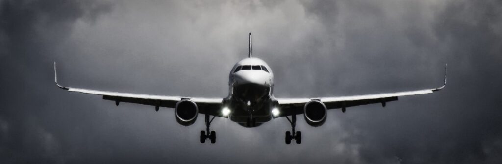 Picture of a plane taking off in dark and cloudy skies