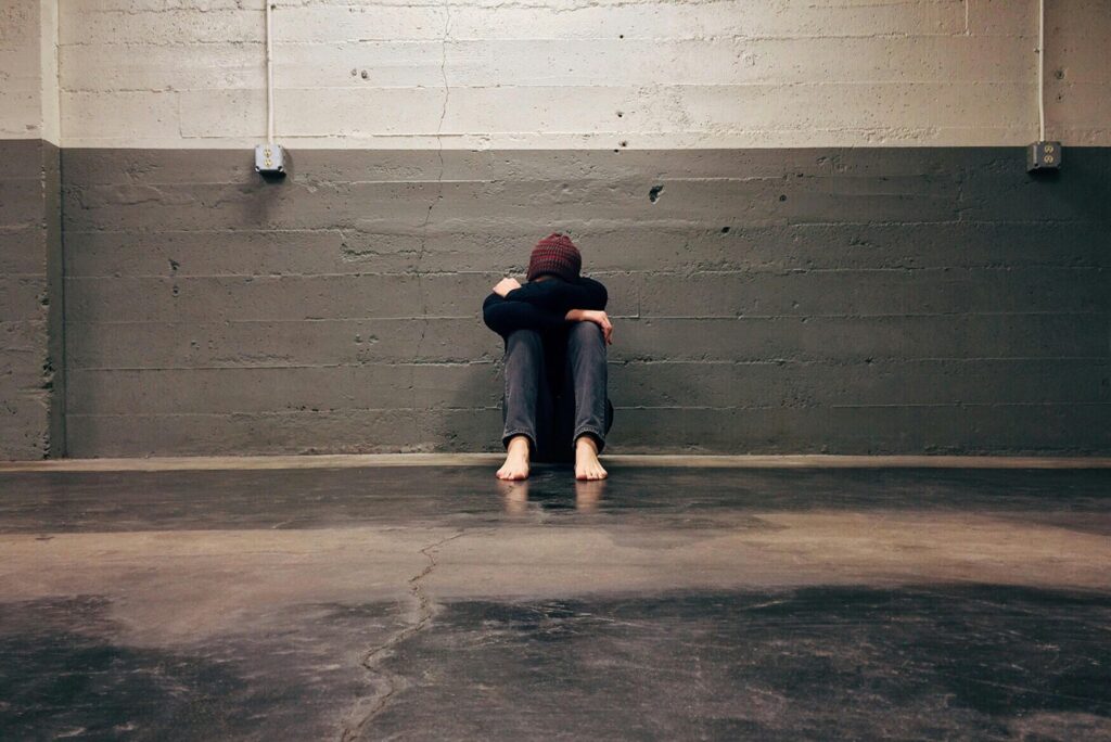 Person in distress with their head in their hands