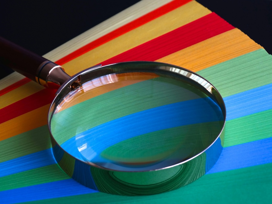 Image of a magnifying glass on coloured paper
