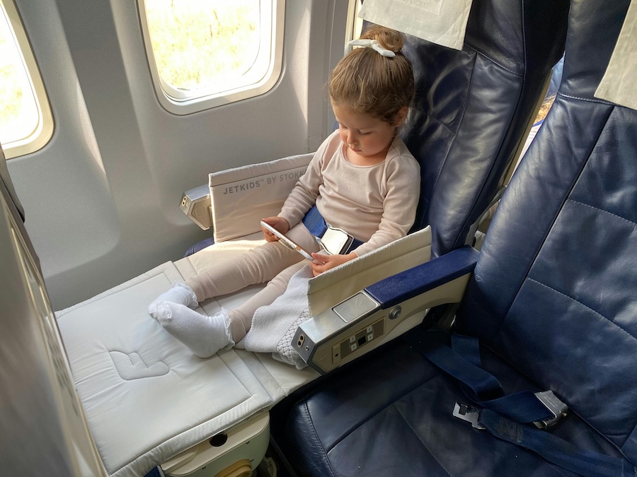 Child on a plane using an iPad