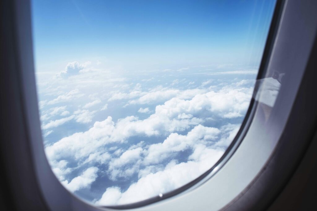 Image of clouds outside a plane window