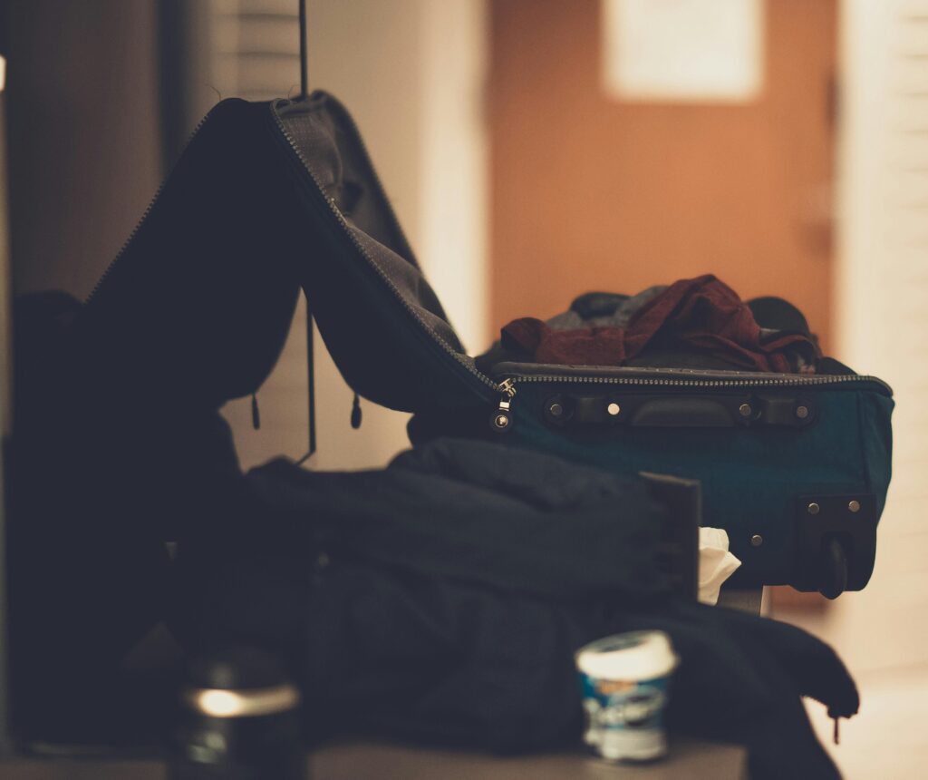 Traveller with their foot up on a suitcase