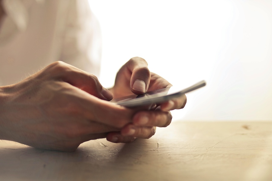 Image of a person's hands using a mobile phone
