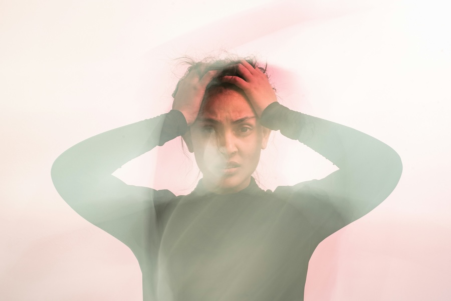 Picture of someone looking anxious with their hands on their head