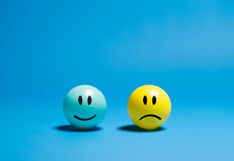 Cartoon image of a happy and sad face