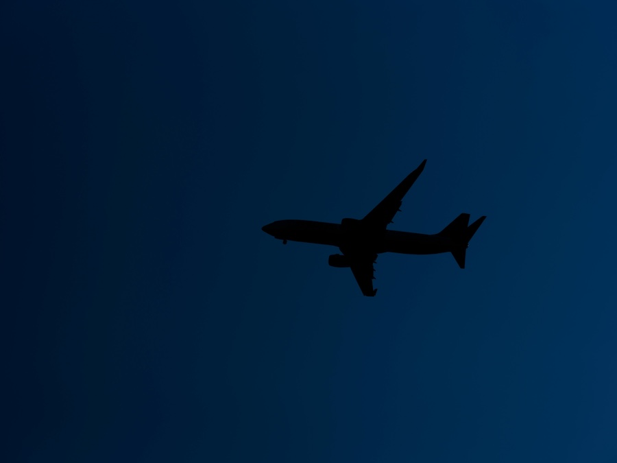 Image of a plane taking off at night in a low contrast image