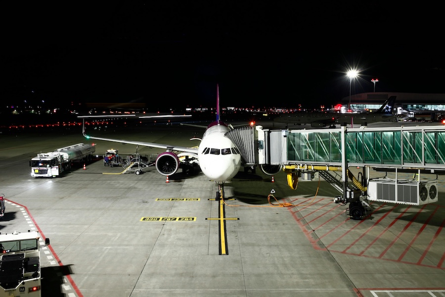 Picture of a plane being loaded at night