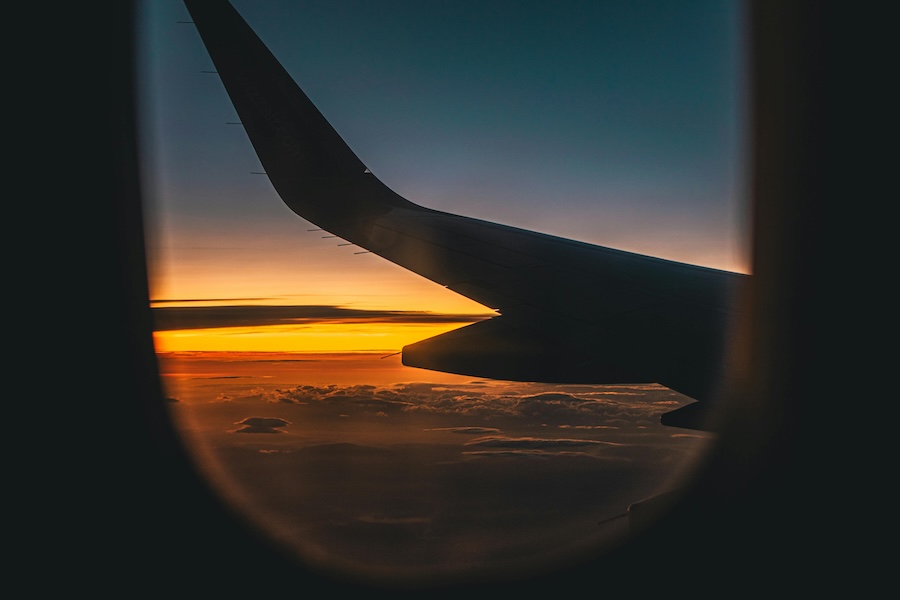 Picture from the plane cabin looking over the wing during sunrise