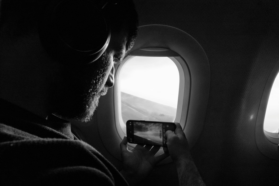 Image of an older adult looking out of the window of a plane