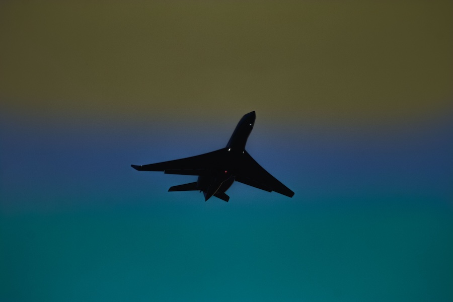Plane taking off into a grey sky