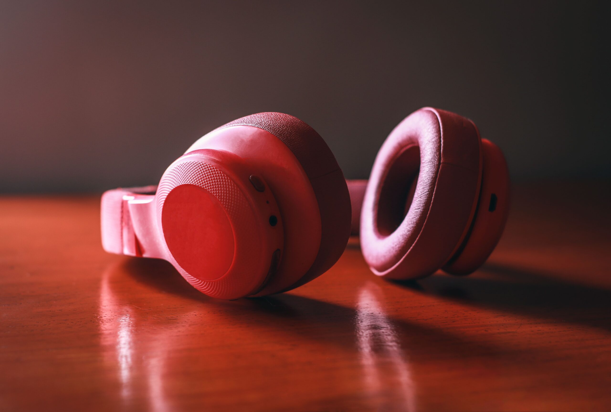 Pink wireless headphones on a table