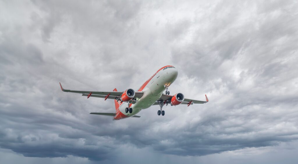 Plane entering grey looking clouds