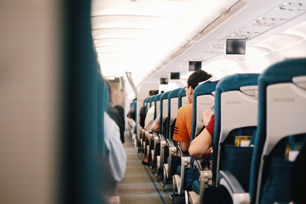 Inside of a plane cabin with nervous looking passengers