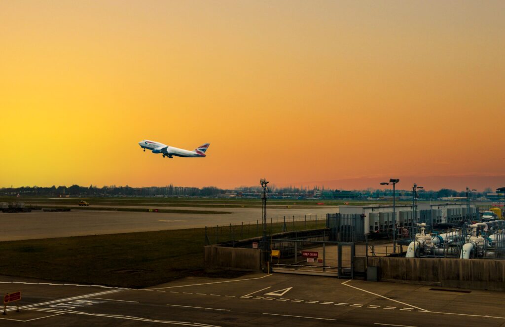 Plane taking off into a beautiful golden sky at sunset