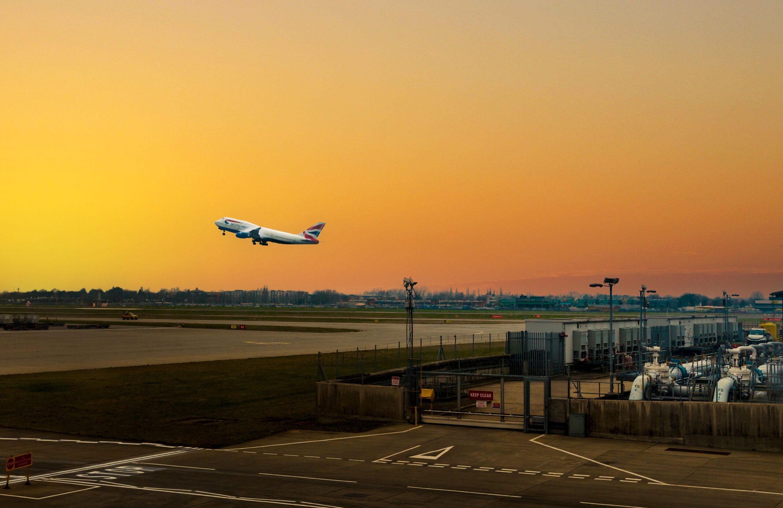 Plane taking off into a beautiful golden sky at sunset
