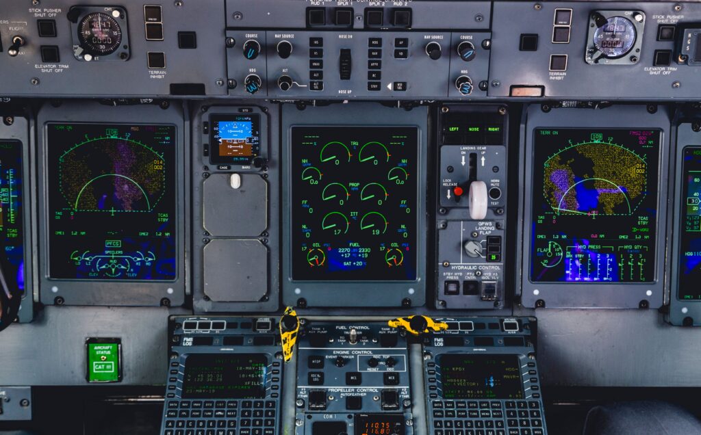 Airplane flight deck with illuminated screens