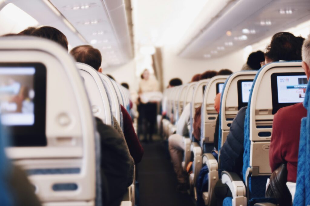 Image of a plane aisle seen from a rear seat with a soft filter
